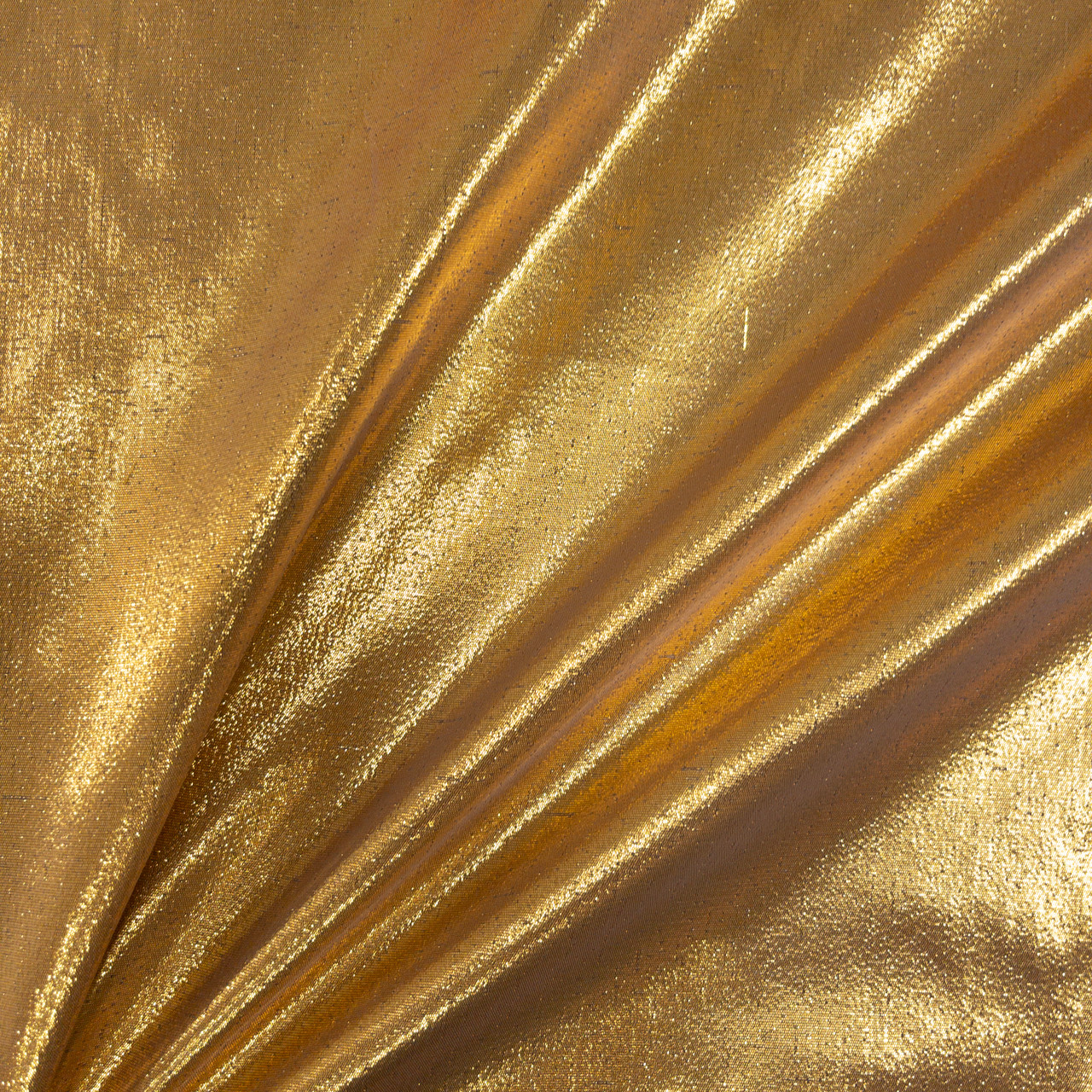 Shiny gold lame fabric catching light